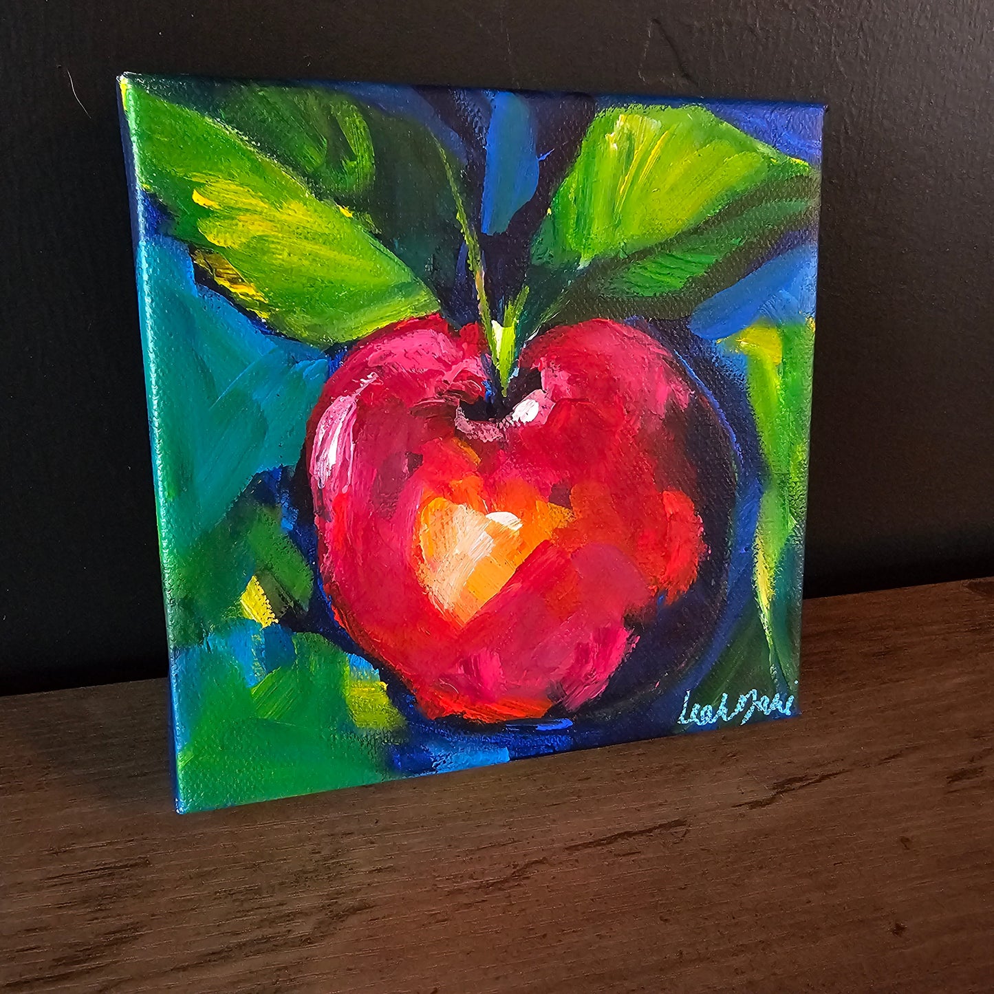 Colorful spring apple mini painting with red and green tones layered over textured acrylic brushwork on canvas.