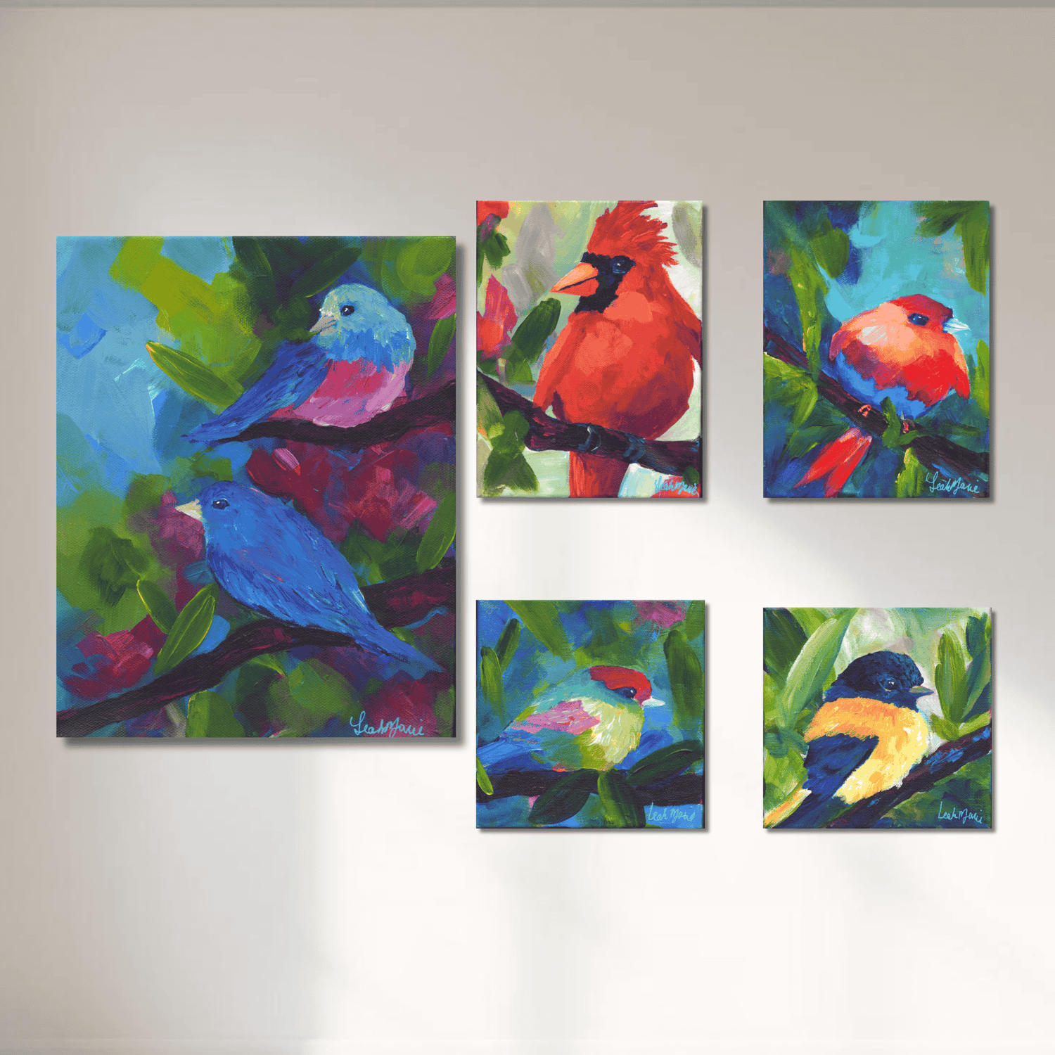 Colorful spring bird mini paintings displayed as a curated gallery wall featuring vibrant cardinal, bluebirds, and expressive brushstrokes on canvas.