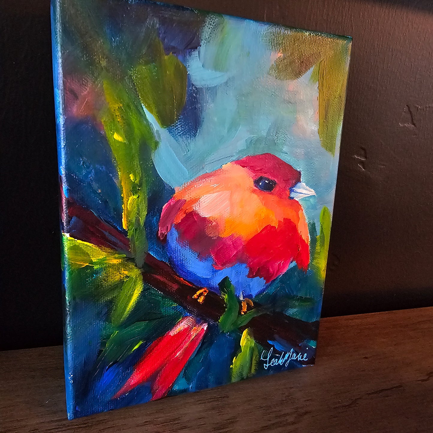 rainbow bird painting on a 6x9 mini canvas by dopamine artist leah marie