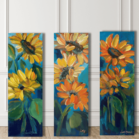 Three vertical paintings of sunflowers on a white paneled wall.